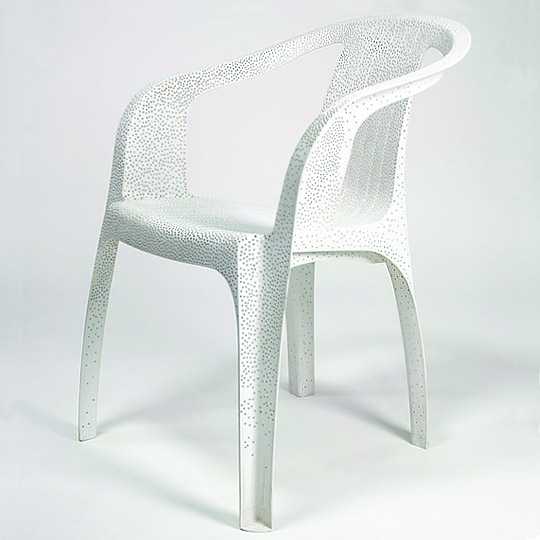 'White Plastic Chair' by Tina Roeder, as part of her series of found/old/decaying garden chairs, 2002.  Individually perforated and sanded in order to give a new lease of life.